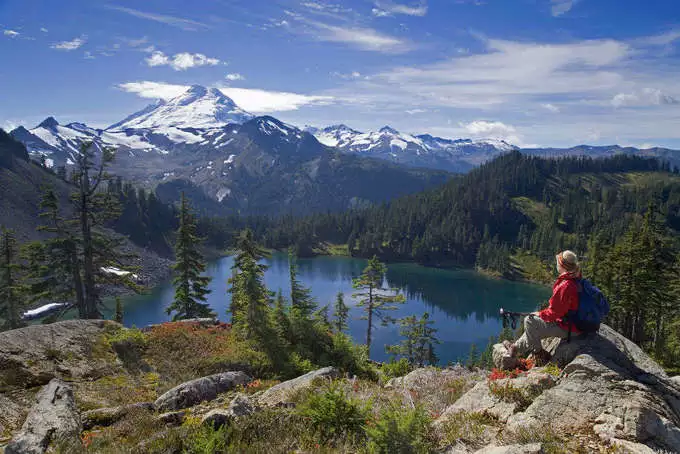 man sit on the top of mountain